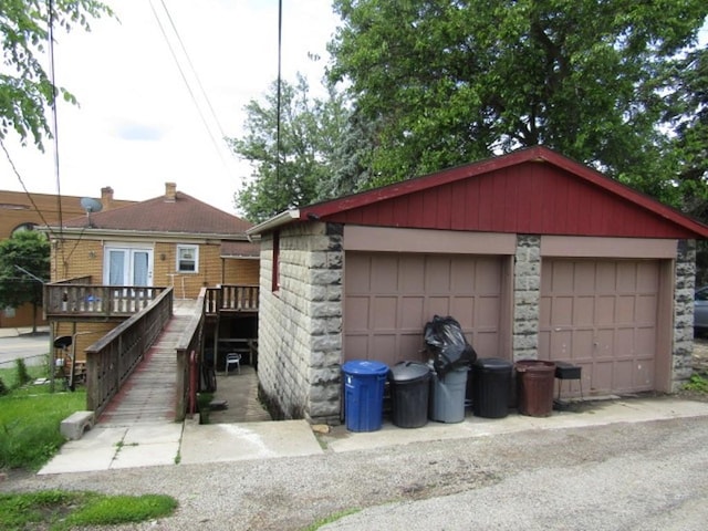 2445 Brownsville Rd, Carrick, PA 15210 - view of front facade featuring a detached garage, an outbuilding, and a wooden deck