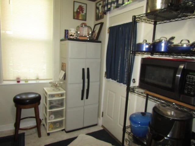 2445 Brownsville Rd, Carrick, PA 15210 - kitchen featuring black microwave and baseboards