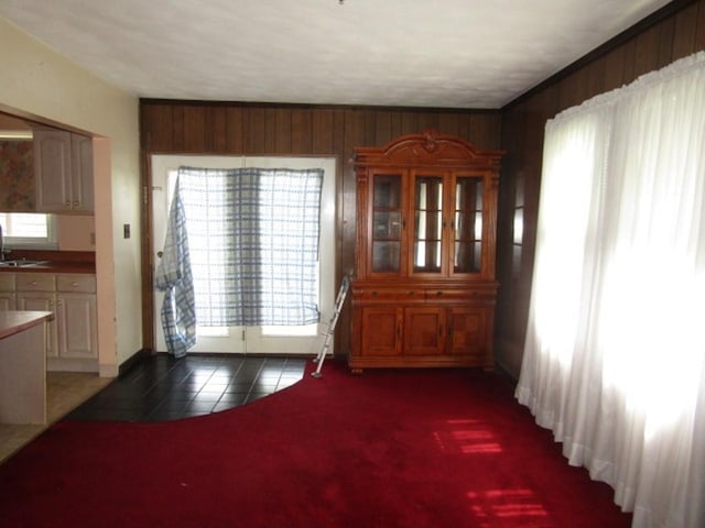 2445 Brownsville Rd, Carrick, PA 15210 - unfurnished dining area featuring tile patterned floors, a sink, wooden walls, and baseboards