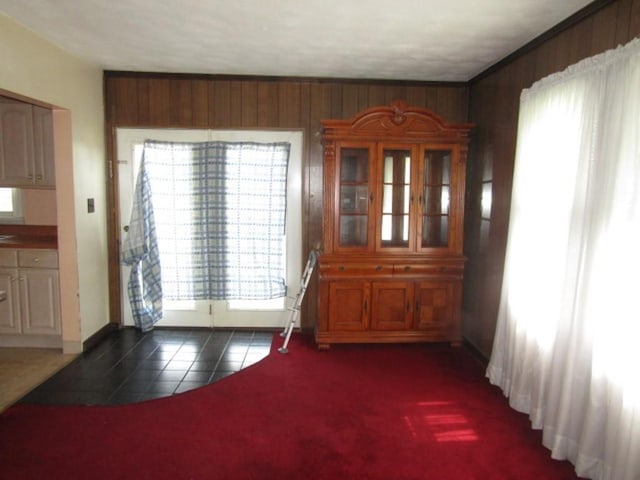 2445 Brownsville Rd, Carrick, PA 15210 - dining room featuring dark tile patterned flooring, wooden walls, and baseboards