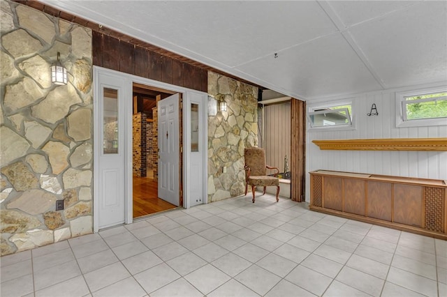 1369 Old Pulaski Rd, Neshannock Twp, PA 16105 - empty room with wood walls and tile patterned flooring