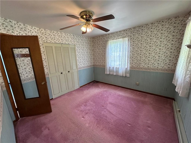 51 Clark Ave, Kiskiminetas Twp, PA 15686 - unfurnished bedroom featuring baseboard heating, a wainscoted wall, wallpapered walls, a closet, and ceiling fan