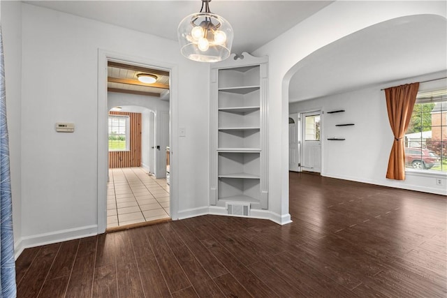 512 Pine Ave, Ellwood City Law, PA 16117 - unfurnished dining area with arched walkways, wood finished floors, a chandelier, and plenty of natural light
