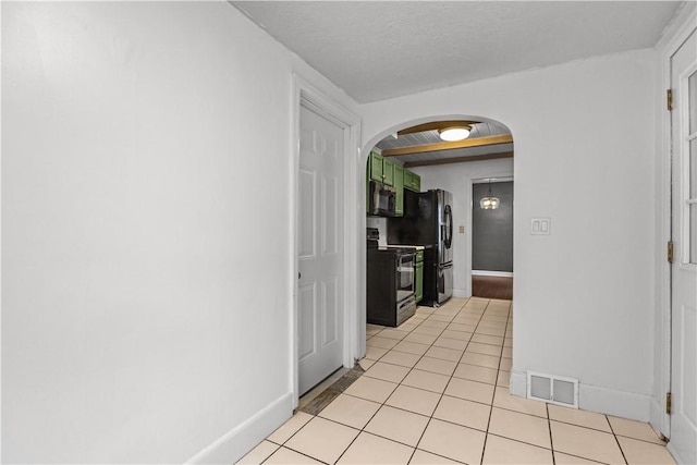 512 Pine Ave, Ellwood City Law, PA 16117 - hall featuring arched walkways, light tile patterned flooring, and baseboards