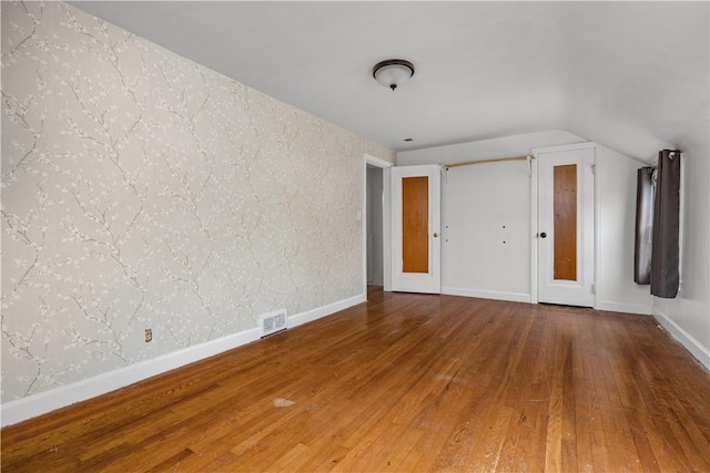512 Pine Ave, Ellwood City Law, PA 16117 - unfurnished room featuring wood finished floors, lofted ceiling, and baseboards