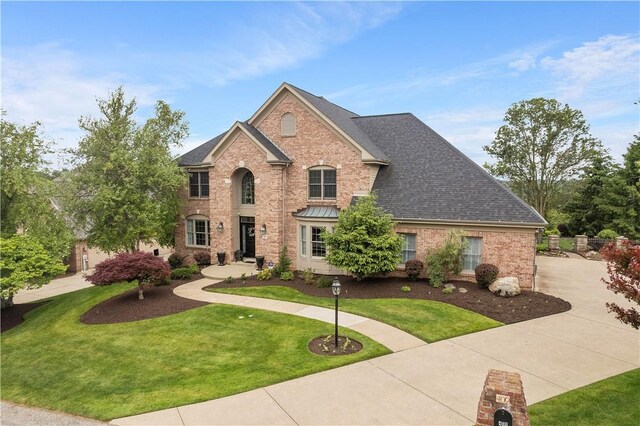 409 Foxwood Ln, Scott Twp Sal, PA 15220 - view of front of home with brick siding, a front lawn, and roof with shingles