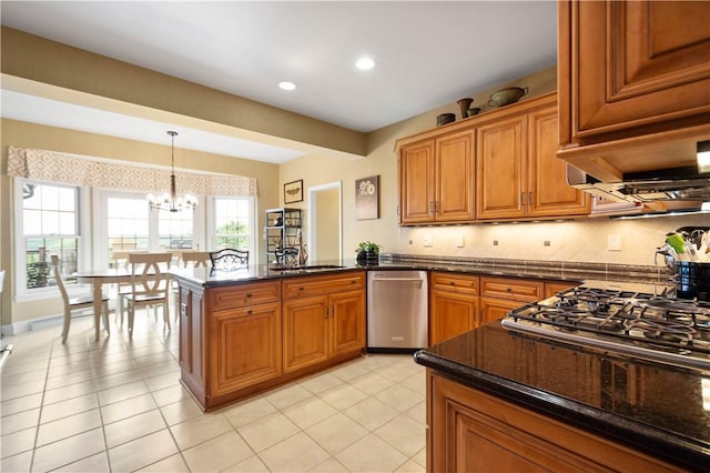 409 Foxwood Ln, Scott Twp Sal, PA 15220 - kitchen featuring appliances with stainless steel finishes, brown cabinets, a peninsula, a chandelier, and decorative light fixtures