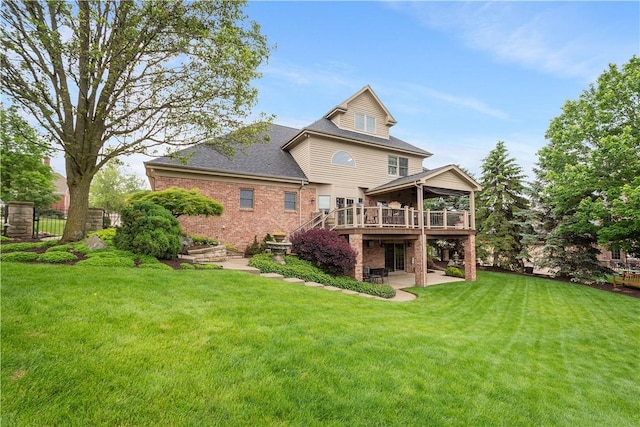 409 Foxwood Ln, Scott Twp Sal, PA 15220 - back of house with a deck, a patio, brick siding, and a shingled roof