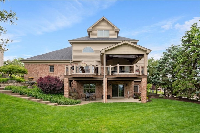 409 Foxwood Ln, Scott Twp Sal, PA 15220 - back of property featuring a lawn, a patio area, brick siding, a wooden deck, and a shingled roof