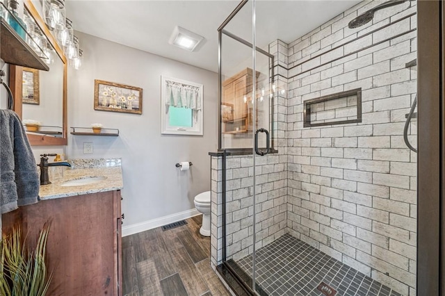 124 Hilton Rd, Unity Twp, PA 15601 - full bath with vanity, a shower stall, wood finished floors, and toilet
