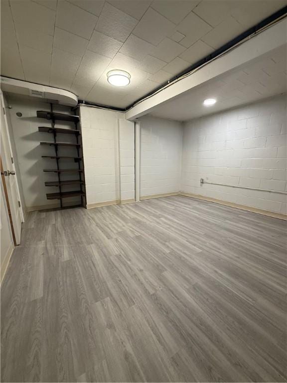 217 Crescent Dr, Hempfield Twp Wml, PA 15601 - finished below grade area featuring wood finished floors, concrete block wall, and baseboards