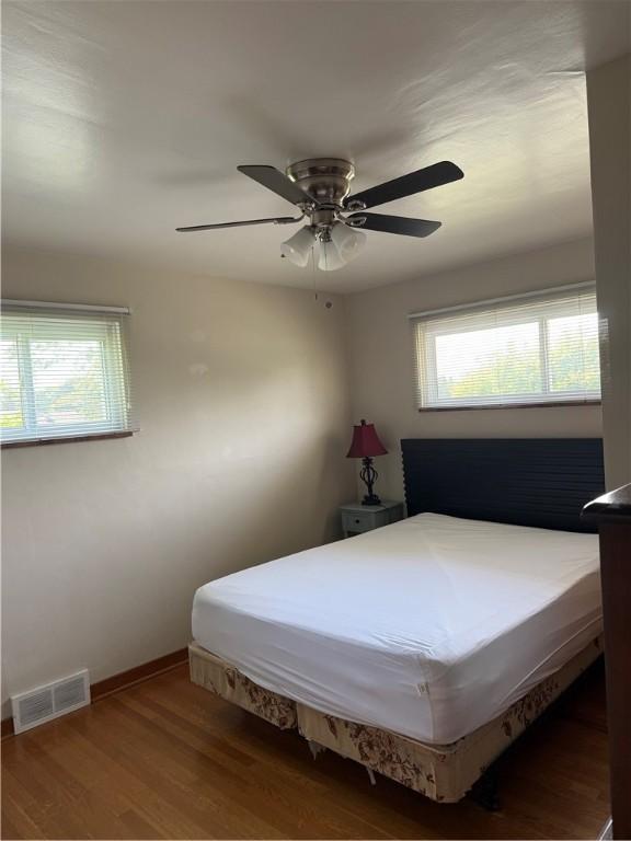 217 Crescent Dr, Hempfield Twp Wml, PA 15601 - bedroom with multiple windows, wood finished floors, and baseboards