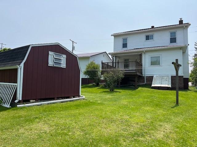 446 Sugar Maple Dr, Windber, PA 15963 - back of house with a gambrel roof, a lawn, a chimney, and a wooden deck