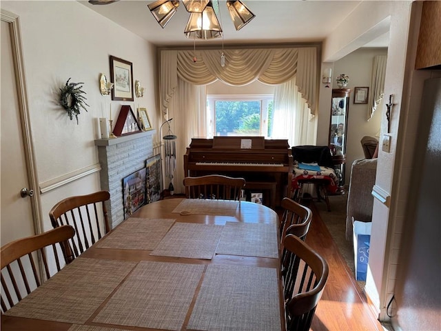 2122 Elizabeth Ct, Export, PA 15632 - dining room featuring a fireplace, wood finished floors, and a ceiling fan