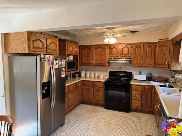 2122 Elizabeth Ct, Export, PA 15632 - kitchen featuring stainless steel appliances, under cabinet range hood, brown cabinetry, and light countertops