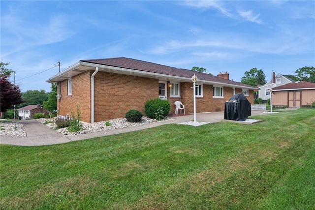 2122 Elizabeth Ct, Export, PA 15632 - back of property featuring brick siding, a lawn, a patio, and a chimney