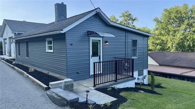 14 Haywood St, Carroll Twp, PA 15063 - back of property featuring a yard, a chimney, and roof with shingles