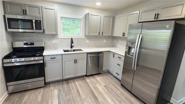 14 Haywood St, Carroll Twp, PA 15063 - kitchen featuring appliances with stainless steel finishes, a sink, light countertops, light wood-style flooring, and recessed lighting