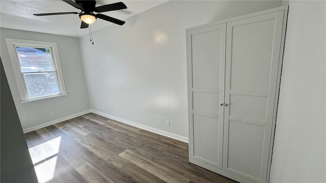 14 Haywood St, Carroll Twp, PA 15063 - unfurnished bedroom featuring dark wood-type flooring, baseboards, a ceiling fan, and a closet