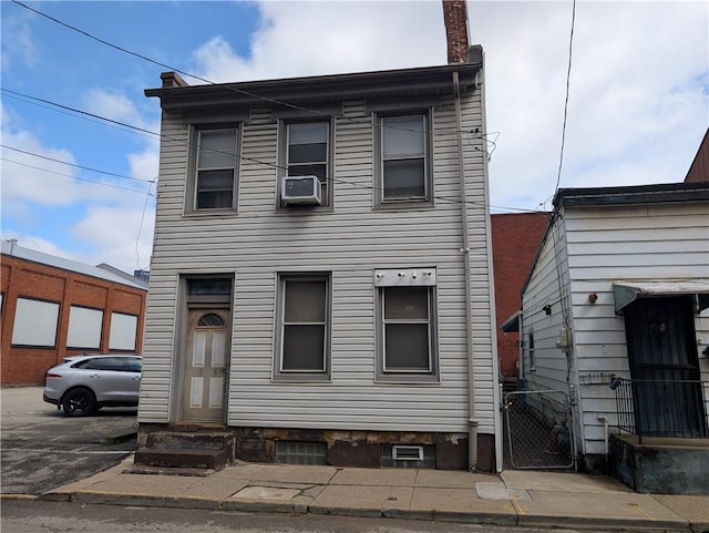 1321-1323 Bingham St, South Side, PA 15203 - townhome / multi-family property featuring entry steps, a chimney, and cooling unit