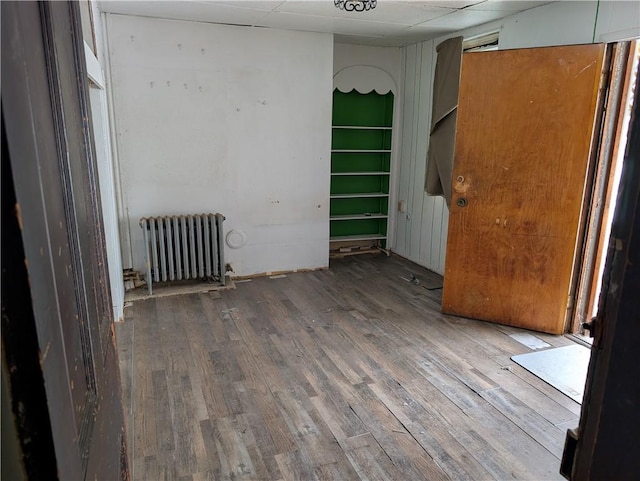 1321-1323 Bingham St, South Side, PA 15203 - empty room featuring radiator heating unit, wood finished floors, and a paneled ceiling