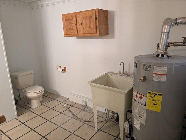 1321-1323 Bingham St, South Side, PA 15203 - bathroom with water heater, toilet, tile patterned floors, and a sink