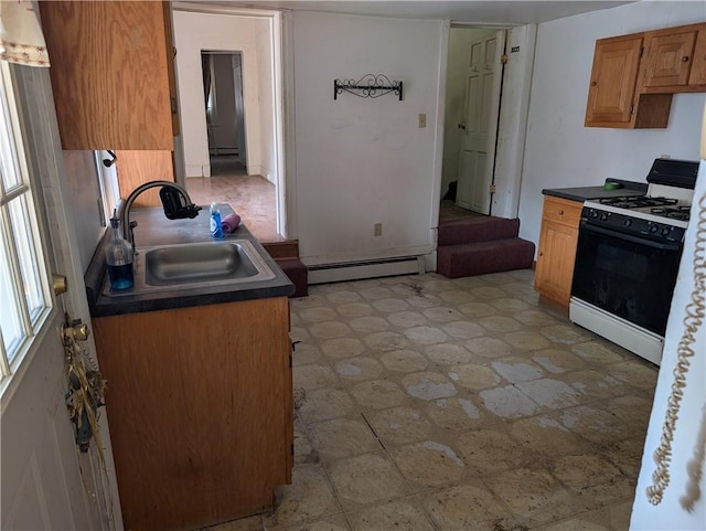 1321-1323 Bingham St, South Side, PA 15203 - kitchen with gas range, a sink, a baseboard radiator, and dark countertops