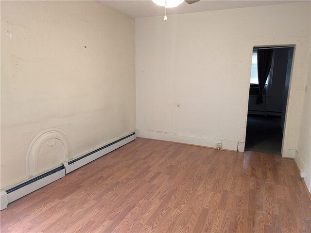 1321-1323 Bingham St, South Side, PA 15203 - unfurnished room with a baseboard radiator, a ceiling fan, wood finished floors, baseboards, and a baseboard heating unit