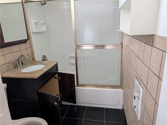 1321-1323 Bingham St, South Side, PA 15203 - bathroom with tile walls, tile patterned flooring, vanity, bath / shower combo with glass door, and toilet