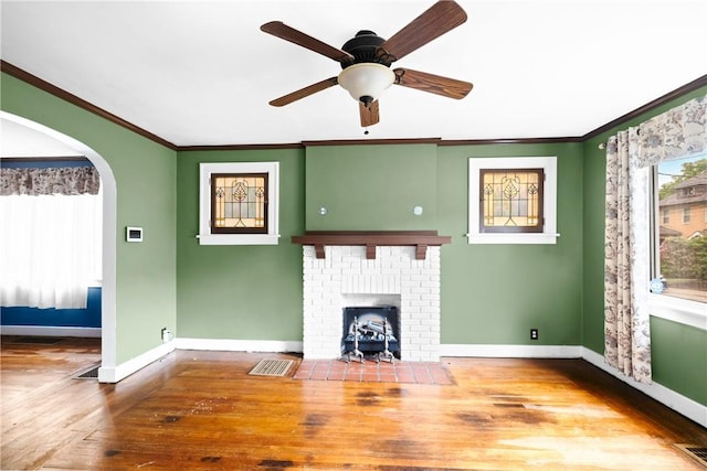 8 Robertson Pl, Etna, PA 15223 - unfurnished living room with wood finished floors, crown molding, baseboards, a ceiling fan, and arched walkways