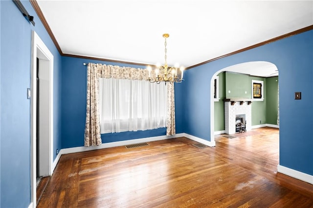 8 Robertson Pl, Etna, PA 15223 - spare room featuring ornamental molding, arched walkways, baseboards, a chandelier, and wood-type flooring