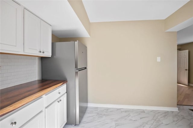 362 Marshall Ave, Observatory Hill, PA 15214 - kitchen featuring light marble finish flooring, freestanding refrigerator, white cabinetry, decorative backsplash, and baseboards