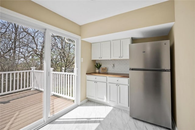 362 Marshall Ave, Observatory Hill, PA 15214 - kitchen featuring freestanding refrigerator, backsplash, white cabinetry, light marble finish flooring, and butcher block countertops