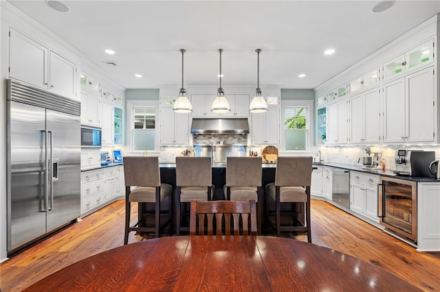 1575 Parkview Blvd, Squirrel Hill, PA 15217 - kitchen with built in appliances, wine cooler, under cabinet range hood, backsplash, and recessed lighting