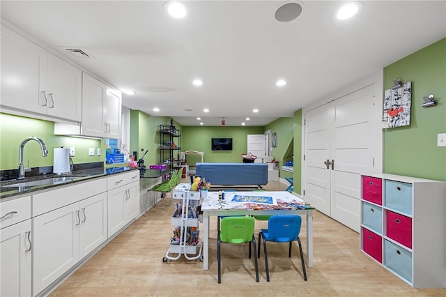 1575 Parkview Blvd, Squirrel Hill, PA 15217 - kitchen with a sink, white cabinetry, recessed lighting, light wood-style floors, and dark stone counters