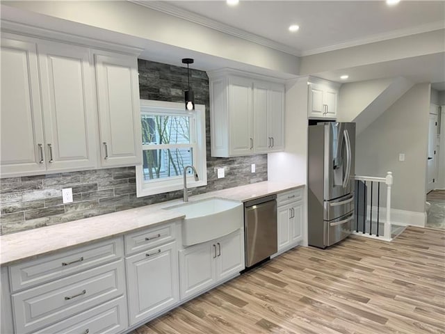 407 E Hillcrest Ave, New Castle/2Nd, PA 16105 - kitchen with appliances with stainless steel finishes, a sink, light wood-style flooring, white cabinets, and crown molding