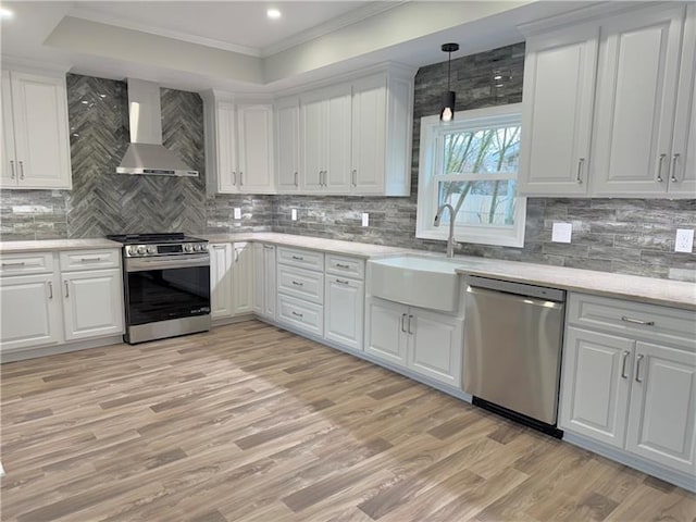 407 E Hillcrest Ave, New Castle/2Nd, PA 16105 - kitchen with appliances with stainless steel finishes, wall chimney exhaust hood, a sink, light wood-style floors, and white cabinetry