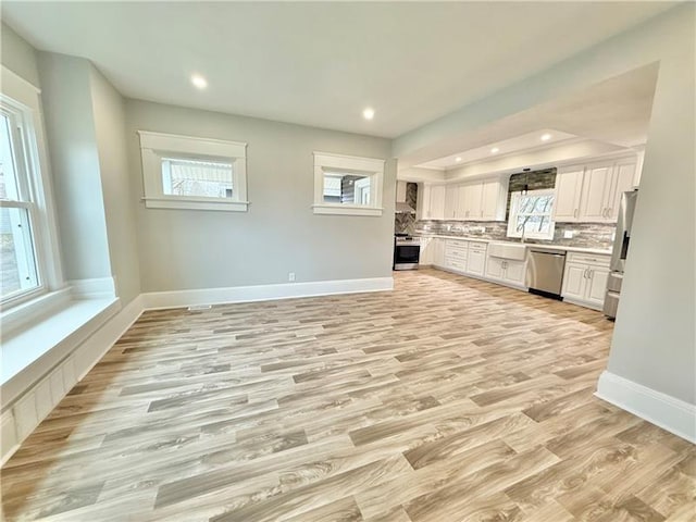 407 E Hillcrest Ave, New Castle/2Nd, PA 16105 - kitchen featuring appliances with stainless steel finishes, light wood-style flooring, white cabinets, tasteful backsplash, and recessed lighting