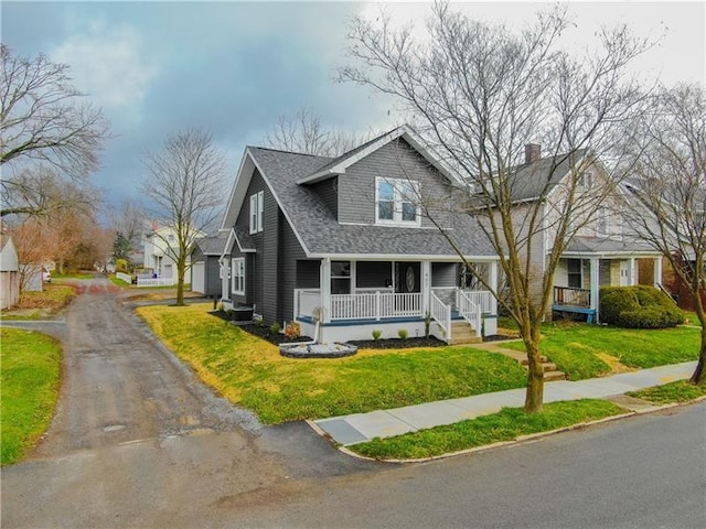 407 E Hillcrest Ave, New Castle/2Nd, PA 16105 - view of front of property with covered porch, a front yard, a chimney, and a shingled roof