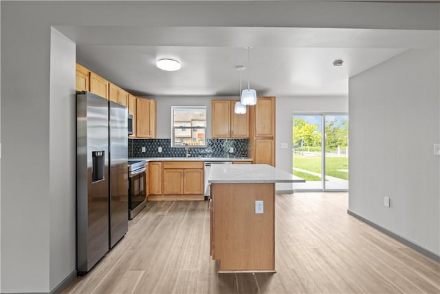 22 Mayflower St, Lincoln-Larimer, PA 15206 - kitchen with stainless steel appliances, light countertops, light wood-style flooring, backsplash, and healthy amount of natural light