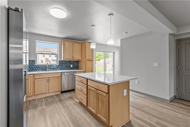 22 Mayflower St, Lincoln-Larimer, PA 15206 - kitchen featuring stainless steel appliances, a sink, light wood-type flooring, light countertops, and backsplash