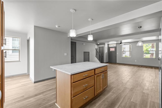 22 Mayflower St, Lincoln-Larimer, PA 15206 - kitchen with light wood finished floors, ceiling fan, hanging light fixtures, open floor plan, and light countertops
