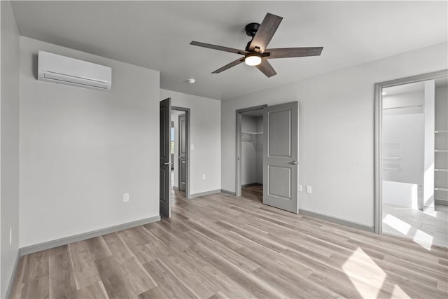 22 Mayflower St, Lincoln-Larimer, PA 15206 - unfurnished bedroom featuring a wall mounted air conditioner, light wood finished floors, baseboards, and ceiling fan