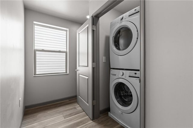 22 Mayflower St, Lincoln-Larimer, PA 15206 - washroom with stacked washer / dryer, wood finished floors, and baseboards