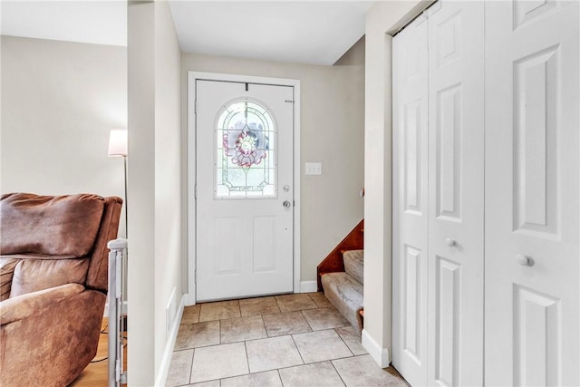 669 Carnival Dr, Plum Boro, PA 15239 - foyer entrance with baseboards, stairway, and light tile patterned floors