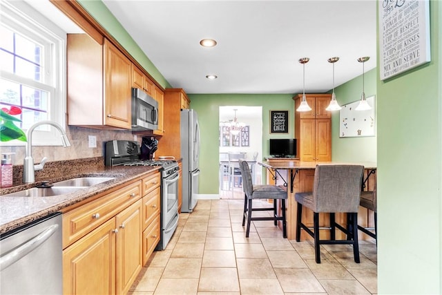 669 Carnival Dr, Plum Boro, PA 15239 - kitchen featuring stainless steel appliances, a sink, dark stone counters, pendant lighting, and a chandelier