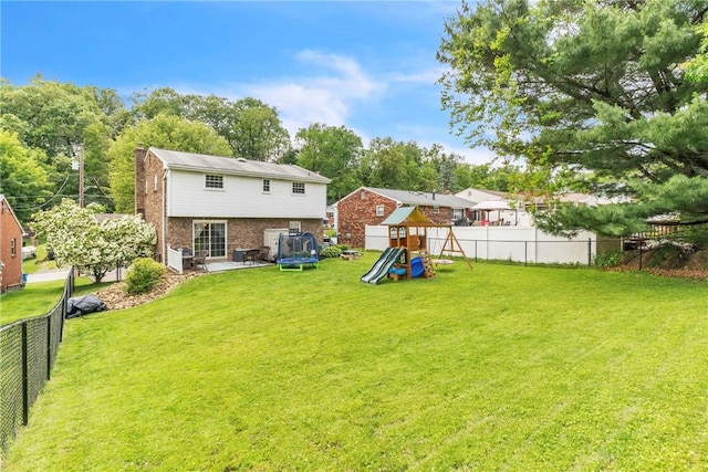 669 Carnival Dr, Plum Boro, PA 15239 - back of property with a playground, brick siding, a chimney, and a trampoline