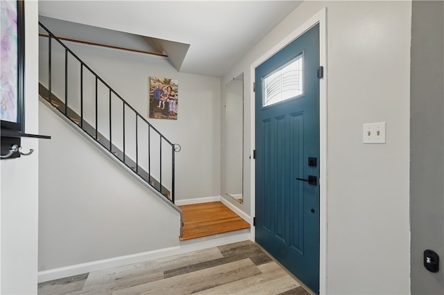 105 Canaveral Dr, Penn Hills, PA 15235 - entrance foyer featuring wood finished floors, stairway, vaulted ceiling, and baseboards