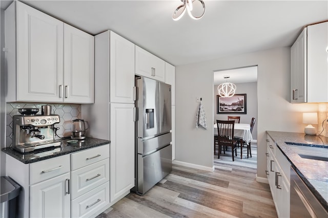 105 Canaveral Dr, Penn Hills, PA 15235 - kitchen featuring appliances with stainless steel finishes, light wood-style floors, tasteful backsplash, white cabinetry, and baseboards
