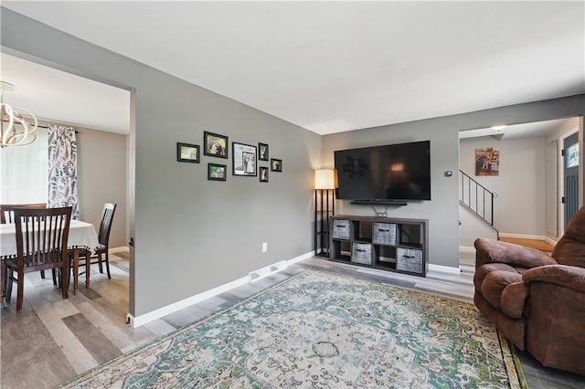 105 Canaveral Dr, Penn Hills, PA 15235 - living area with wood finished floors, stairs, baseboards, and a chandelier